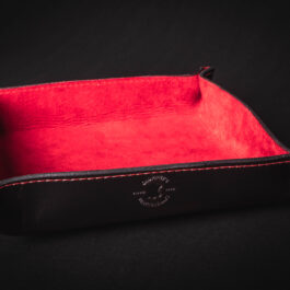 A black and red Handmade Leather Valet Tray with a red lining.