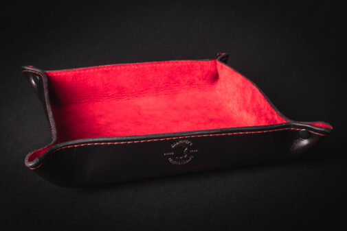 A black and red Handmade Leather Valet Tray with a red lining.