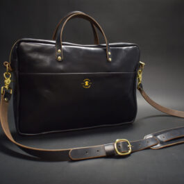A Horween Leather Briefcase Satchel with a brown strap.