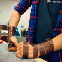 a man with blue flannel wearing a Woven leather Cuff - renaissance clothing - renaissance clothing men - renaissance clothing women - renaissance clothing near me - renaissance art clothing - renaissance era clothing - renaissance costume ideas