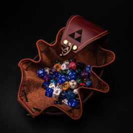 A Handmade Leather Dice Bag filled with dice and dice holders.