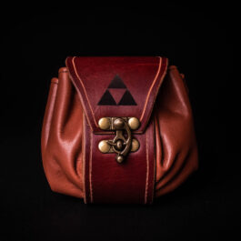 A handmade leather dice bag with a triangle design on it.