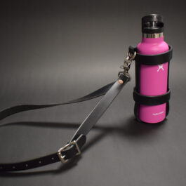A pink Water Bottle Holster with a leash attached to it.