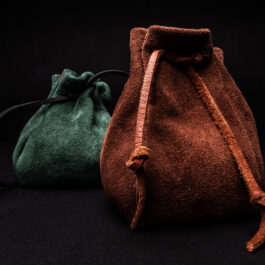 Two brown and green Leather Coin Pouches sitting side by side.