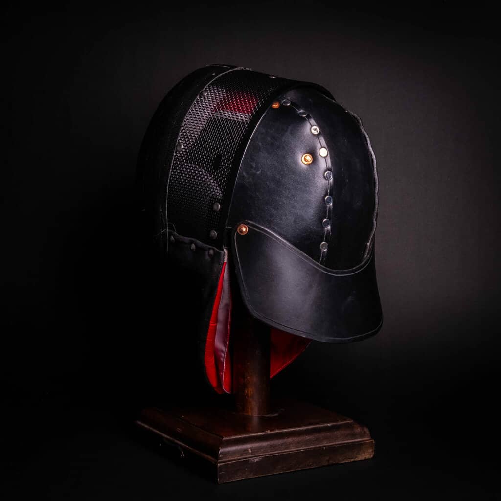A Leather Back of Head Protector Version 2 with a red ribbon around it.