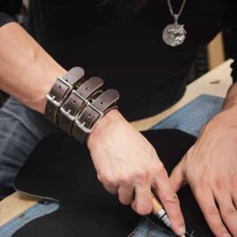 a person wearing The "Dav" Wrist Cuff on a table.