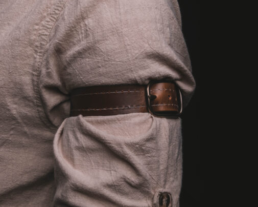 a close up of a person wearing Leather Dress Suspenders.