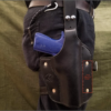 a person with a blue knife in a Custom Thigh Holster.