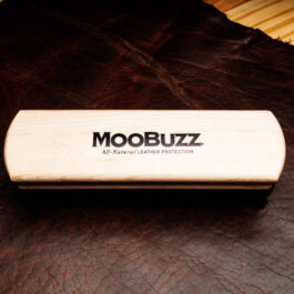 a horsehair brush with a wooden handle that says "moobuzz" across its length"