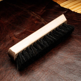 a horsehair brush with a wooden handle.