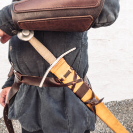 A man holding a Wood Core Scabbard for the Albion I:33 in his back pocket.