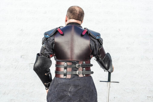 the back view of the man in the leather armor