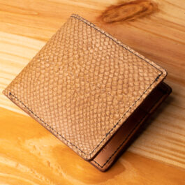 A leather wallet sitting on a wooden table