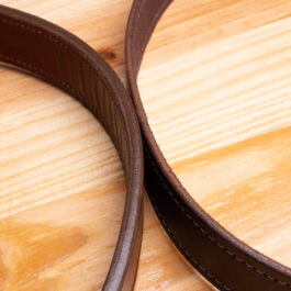 A brown Leather belt on a wooden table