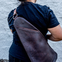 A woman with a leather sling bag on her back